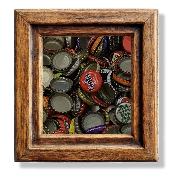 A close up of a pile of bottle caps in a wooden frame.