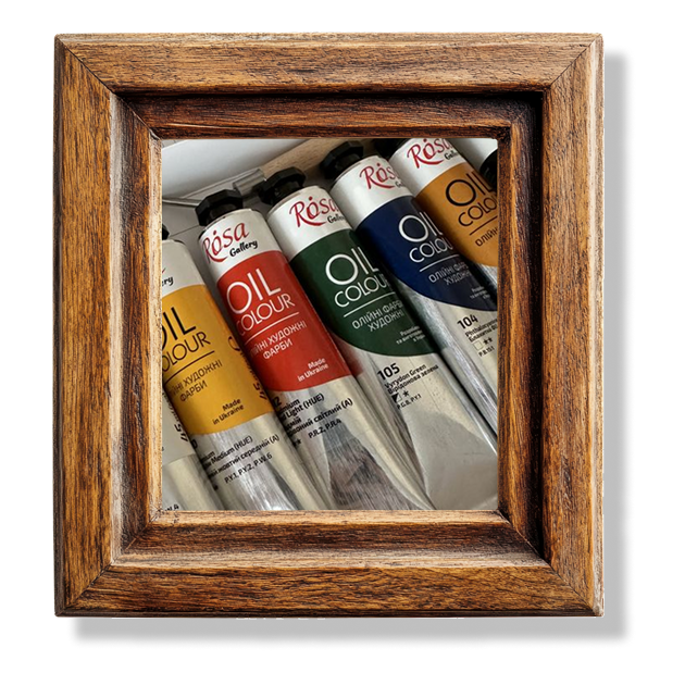 A close up of different tubes of oil based paints in a wooden frame.
