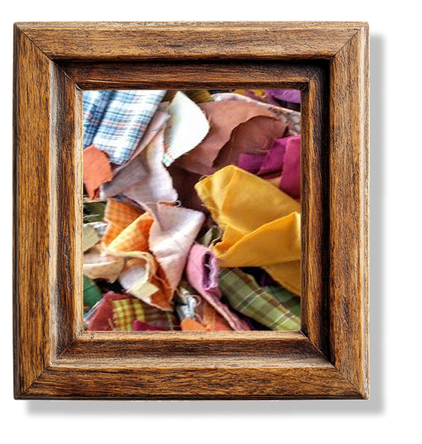 A jumble of different scraps of fabrics in a wooden frame.